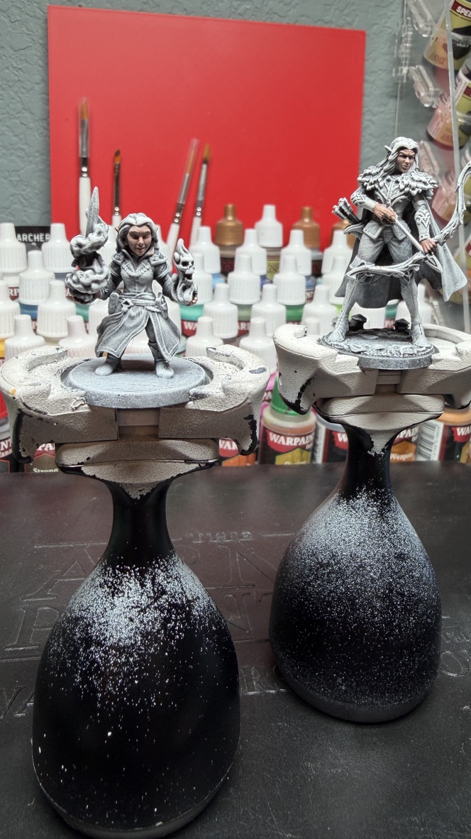 Zenithal-primed minis staged on painting handles