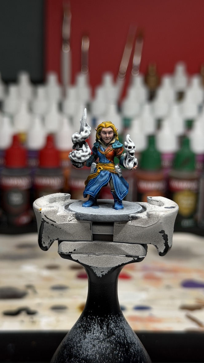 Finished Yssala on the painting handle, a purple conjured blade in one hand and a skull-flame in the other